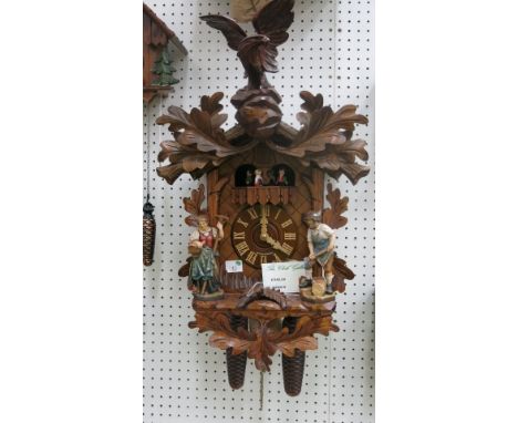 * German large weight driven mechanical cuckoo clock with musical action eagle and figure mounts. RRP £1140 