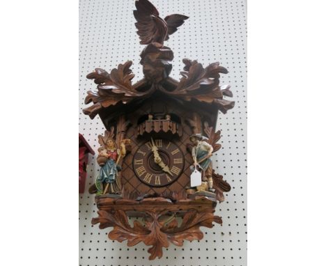 * German large wooden cased cuckoo clock with weight driven mechanical movement, figure mount and eagle finial 