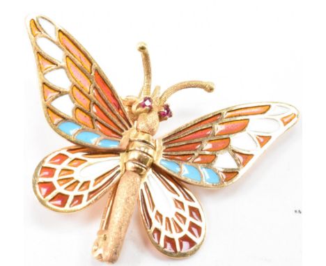 A vintage gold plique a jour enamelled butterfly brooch. The brooch having ruby set eyes with posable wings. Marked 8k spain 
