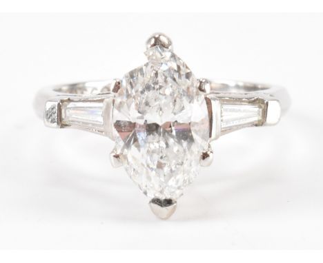 A vintage platinum and diamond ring. The ring being set with a marquise cut diamond with two trapeze&nbsp; cut diamonds to th