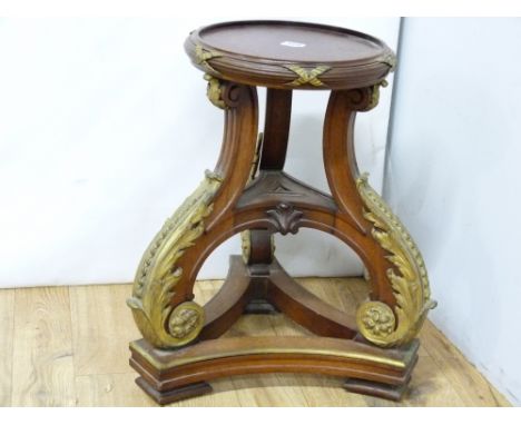 French Empire style pedestal, the circular top with gilt metal ribbon mouldings on downswept tripod supports with heavy gilt 