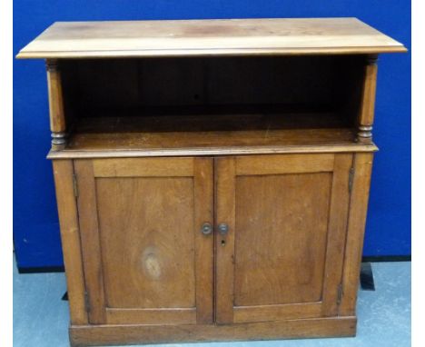 19th century mahogany side cupboard with open upper shelf above pair of single panel doors on plinth base. 101cm wide.