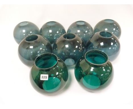 Eight green glass lamp shades in globe form, various hole sizes.&nbsp;Condition report:&nbsp;There were originally nine but o