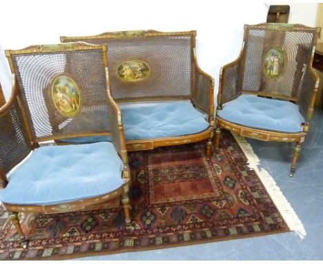 Satinwood bergère suite, c.1890's, comprising two seater settee &amp; pair of armchairs, each with flower &amp; foliate paint