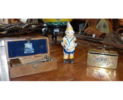 Painted cast iron clown money box, small Persian brass casket and a Wilkinson Sword safety razor, boxed