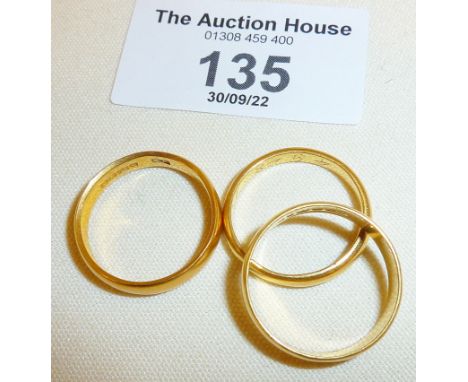 Two fully hallmarked 22ct gold wedding bands, and another gold ring unmarked. Total approx. weight 12g.