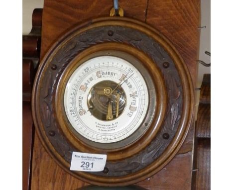 Edwardian aneroid barometer in carved wood frame, 8" diameter
