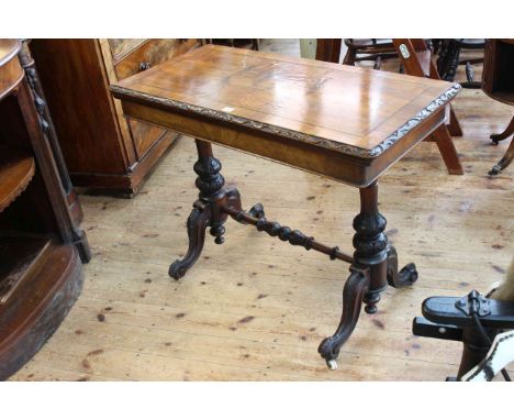 Victorian walnut fold top card table raised on turned carved pillars to four scrolled legs joined by turned stretcher, 76cm h