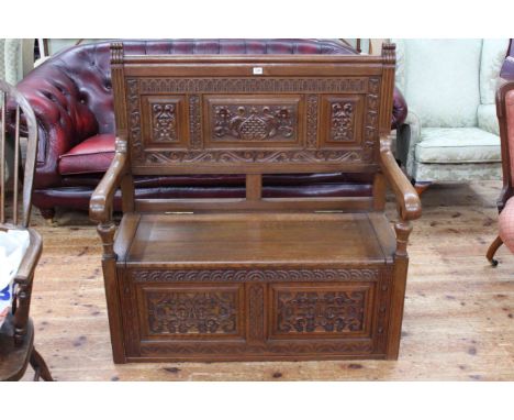 Carved oak box hall bench, 110cm high by 107cm wide by 56cm deep.