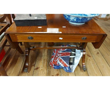 A 68cm reproduction mahogany and cross banded sofa table with frieze drawer, set on shaped standard ends