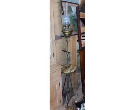A decorative brass telescopic oil lamp standard with circular onyx surface, set on a trefoil base with barley twist supports 