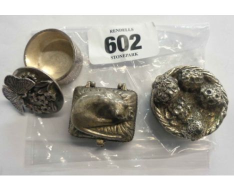 A bag containing two decorative pewter trinket boxes and a metal paperweight