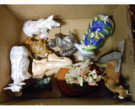 A box containing a quantity of ceramic and resin figurines including SylvaC dog, Cow Parade silly cow, etc.