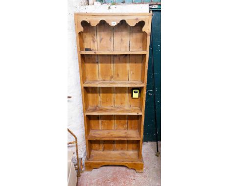 A 68cm pine five shelf open bookcase, set on a bracket base - 1.8m high