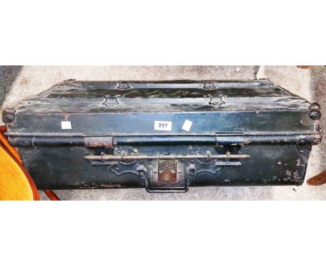 A 70cm antique japanned metal and wooden bound Jones Brothers travelling trunk with rail latch closure and internal labels