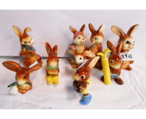 Eight Goebel pottery figurines, depicting rabbits in comical poses
