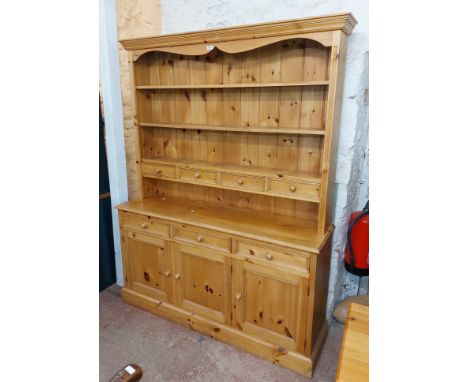 A 1.51m modern pine two part dresser with three shelf open plate rack and four spice drawers over a base with three frieze dr