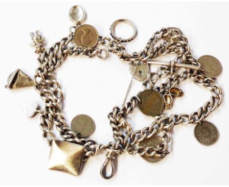 An old silver Albert watch chain (as a charm bracelet), set with mainly cupro-nickel coins, silver button, etc.