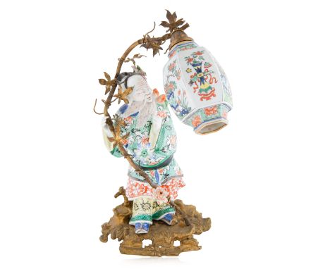 A FRENCH PORCELAIN LAMP ON AN ORMOLU BASE OF A GUARD, LATE 19TH-EARLY 20THa guard porcelain figurine with converted base, the