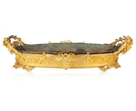 A FRENCH ORMOLU JARDINIERE IN THE NAPOLEON III STYLE, LATE 19TH CENTURY the base of ovoid form, two handles, formed as foliat