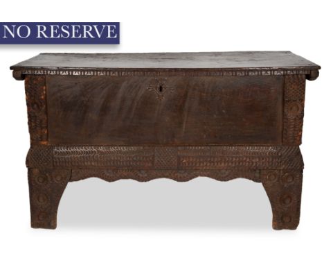 A CARVED DARK WOODEN CHEST, ALPINE REGION, 17TH CENTURYthe carved chest, with possibly African influence, with a geometric ca