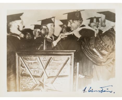 [EINSTEIN] A SIGNED PHOTOGRAPH OF EINSTEIN RECEIVING AN HONORARY DIPLOMA FROM YESHIVA UNIVERSITY, NEW YORK CITY, 1934black-an