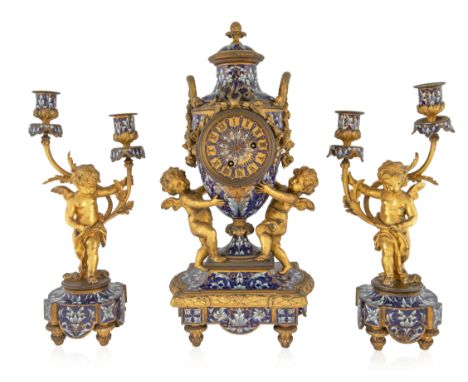 A FRENCH ORMOLU AND CHAMPLEVE ENAMELLED THREE-PIECE GARNITURE, 19TH CENTURY the set with a conforming foliate and floral moti