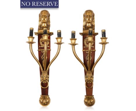 A PAIR OF EGYPTIAN REVIVAL WOOD AND GILT BRONZE SCONCES, 20TH CENTURY each three-light, the body of solid dark wood, the term