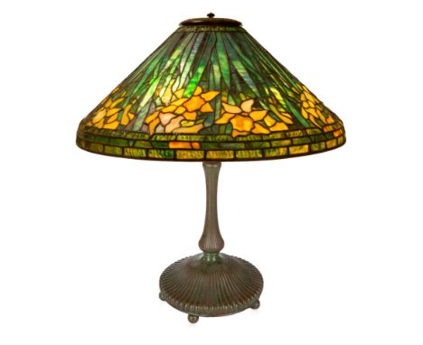 A MODERN 'DAFFODIL' TABLE LAMP, MANNER OF TIFFANY STUDIOSstained glass and bronze, the base with ribbed design on ball feet, 