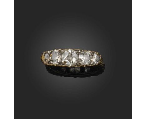 A late Victorian diamond half hoop ring, set with graduated old circular-cut diamonds and diamond pointers in carved and pier