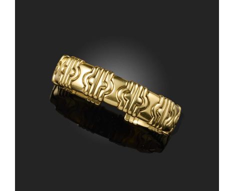 No reserve - a gold and steel bangle, of flexible design, composed of modular gold links threaded onto a steel core, inner cu