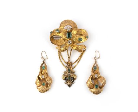 A Victorian emerald and diamond demi-parure, mid 19th century, comprising: a brooch and pair of earrings, each of ribbon scro