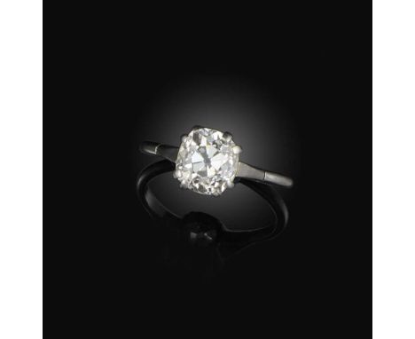 A diamond solitaire ring, first half 20th century, claw-set with an antique cushion-shaped diamond weighing approximately 2.7