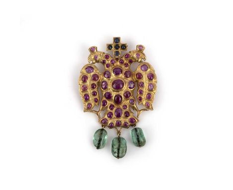 An emerald, ruby and diamond brooch/pendant, designed as the Imperial double-headed eagle, surmounted by a cross, set with ca