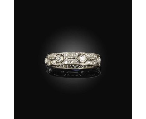 An Art Deco diamond eternity ring, France, 1920s, of openwork construction, collet-set with circular-cut diamonds, spaced by 