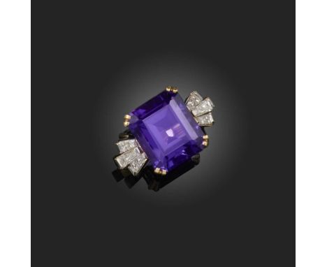 An amethyst and diamond ring, claw-set with a step-cut amethyst, between shoulders set with tapered baguette diamonds, mounte