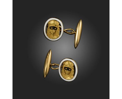 A pair of gold and enamel cufflinks, each designed as a lady in a Harlequin mask in black enamel, within an oval border of wh