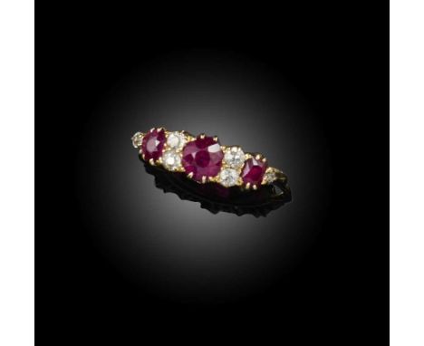 A ruby and diamond ring, early 20th century, set with three circular-cut rubies, spaced by circular-cut diamonds, mounted in 