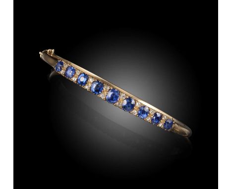 A Victorian sapphire and diamond bangle, set with graduated cushion-shaped sapphires spaced with pairs of diamonds in yellow 