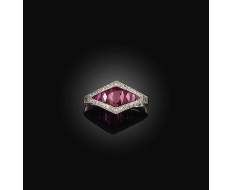 No reserve - a ruby and diamond ring, set with an oval ruby between tapering calibré-cut ruby shoulders, within a border of s