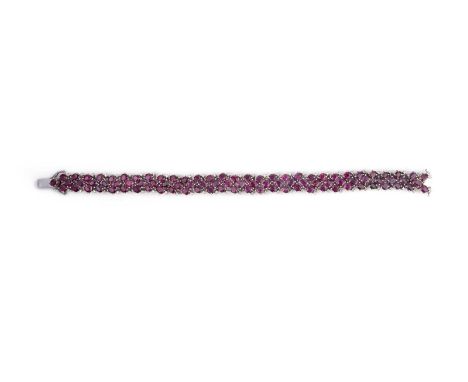 No reserve - a ruby and diamond bracelet, the articulated strap set with oval rubies totalling approximately 13.00 carats, ac