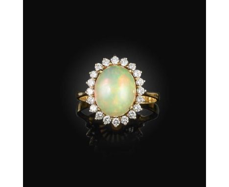 An opal and diamond cluster ring, designed as a cabochon opal set within a surround of brilliant-cut diamonds, mounted in gol