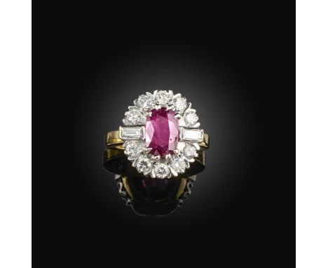 A ruby and diamond ring, of cluster design, set with an oval ruby within a surround of diamonds, mounted in platinum and 18ct