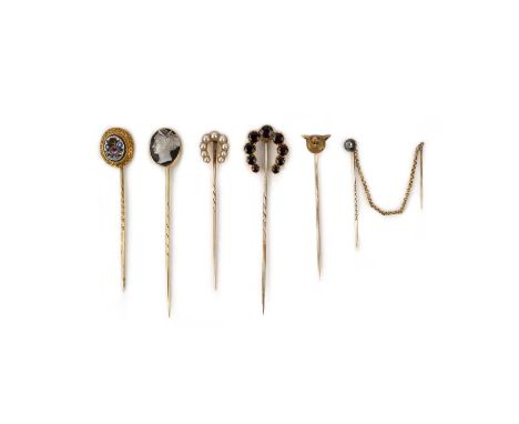 A collection of six stick pins, late 19th century, comprising stick pins topped with: a horseshoe in half pearls, pearls unte