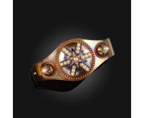 A Victorian seed pearl, enamel and gold bangle, centring on a star motif set with seed pearls and blue enamel on a circular g