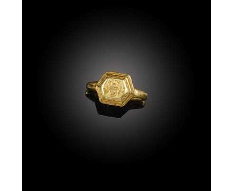 An early medieval gold ring, Java, circa 9th-10th century, of stepped hexagonal outline with incised cord decoration, engrave