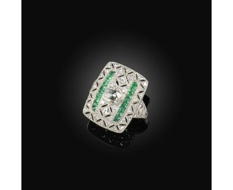 No reserve - an emerald and diamond ring, centring on a rose-cut diamond, within a rectangular openwork platinum plaque, mill