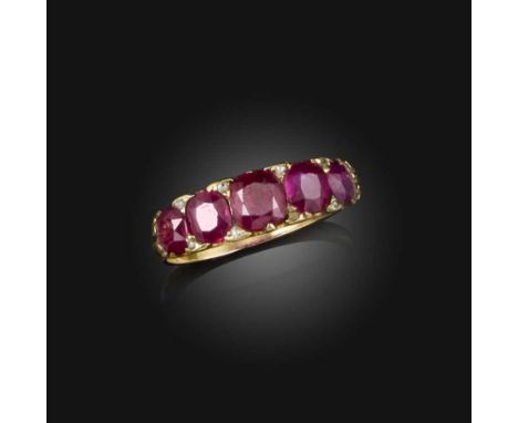 A late 19th century ruby five stone ring, set with graduated cushion-shaped rubied and diamond pointers in carved and pierced