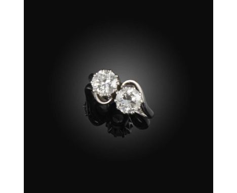 A diamond ring, of toi et moi design, set with two circular-cut diamonds, each weighing approximately 1.00 carat, mounted in 