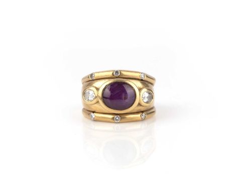 A star ruby and diamond ring, circa 2000, the wide band collet-set with a cabochon star ruby, between oval diamonds, the bord